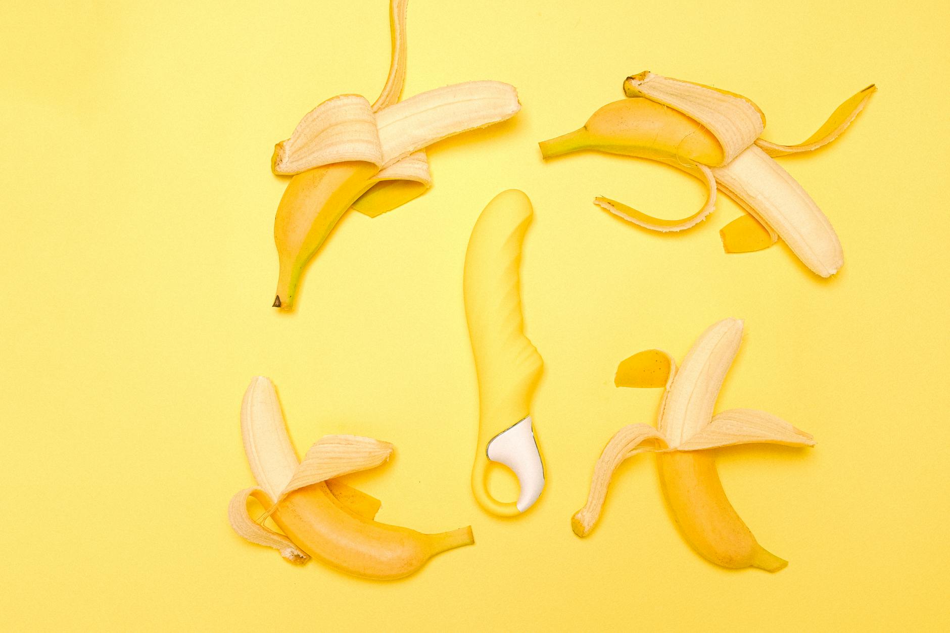 Yellow lemon clitoral vibrator on bright background